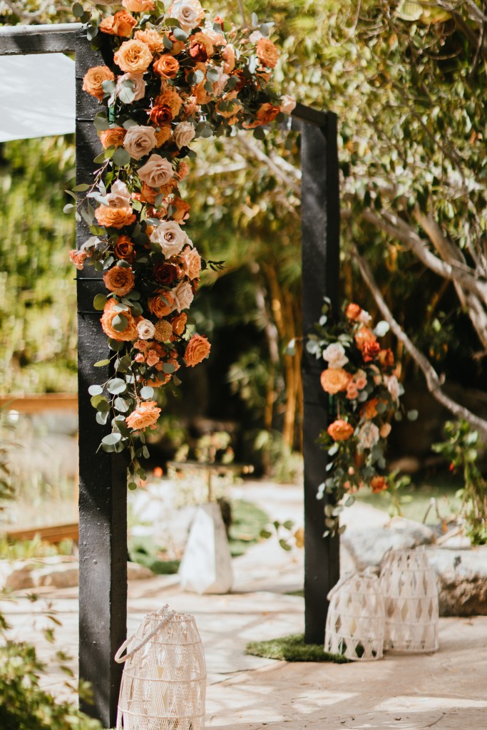 chuppah with warm floral arrangement